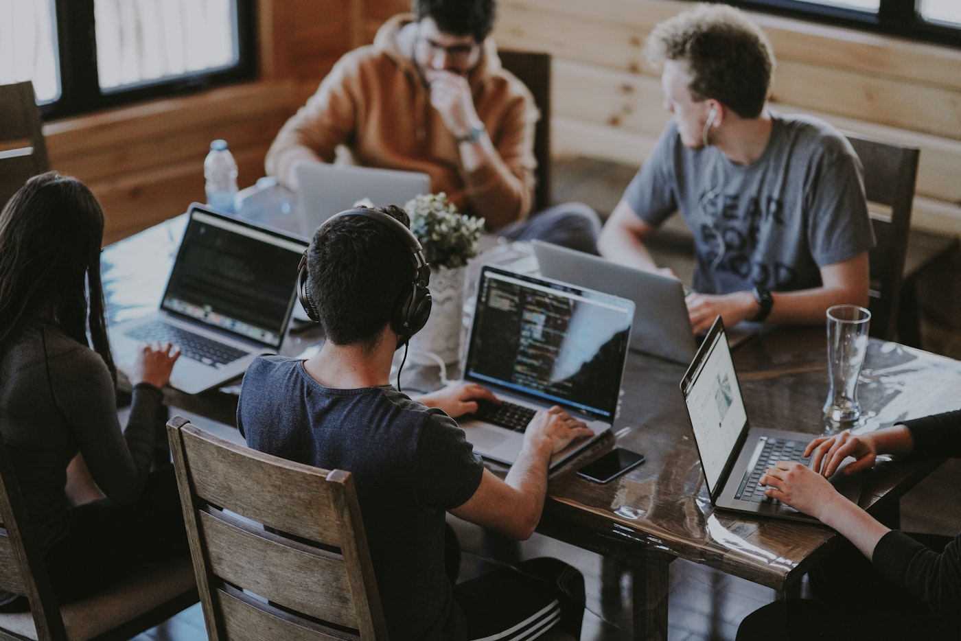 Team collaborating around laptops in an office