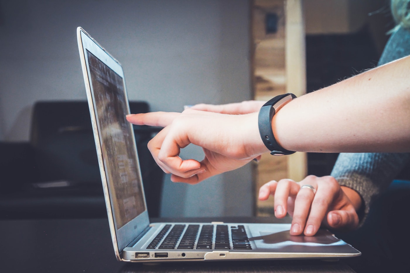 People looking at a laptop screen together while working