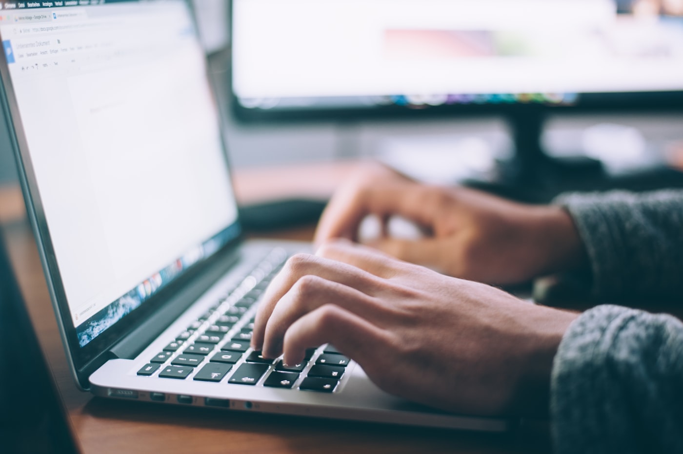 Person working on a laptop in a home office setting